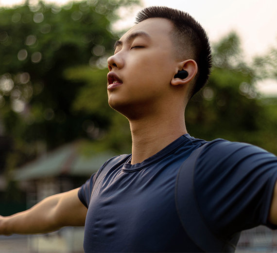 Man with lung condition outside doing yoga with the help of respiratory counselling.